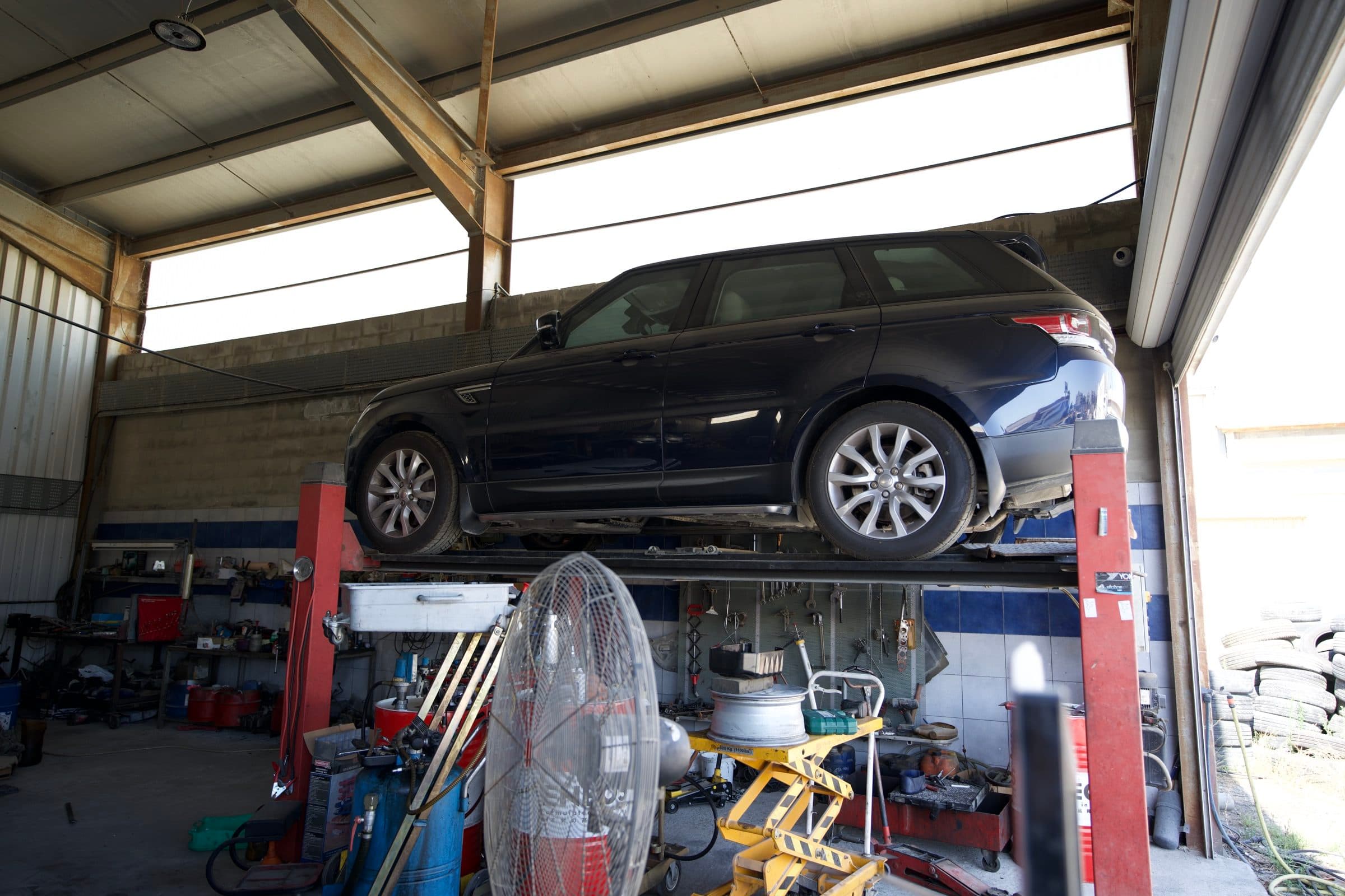 An estate car raised for an underbody check