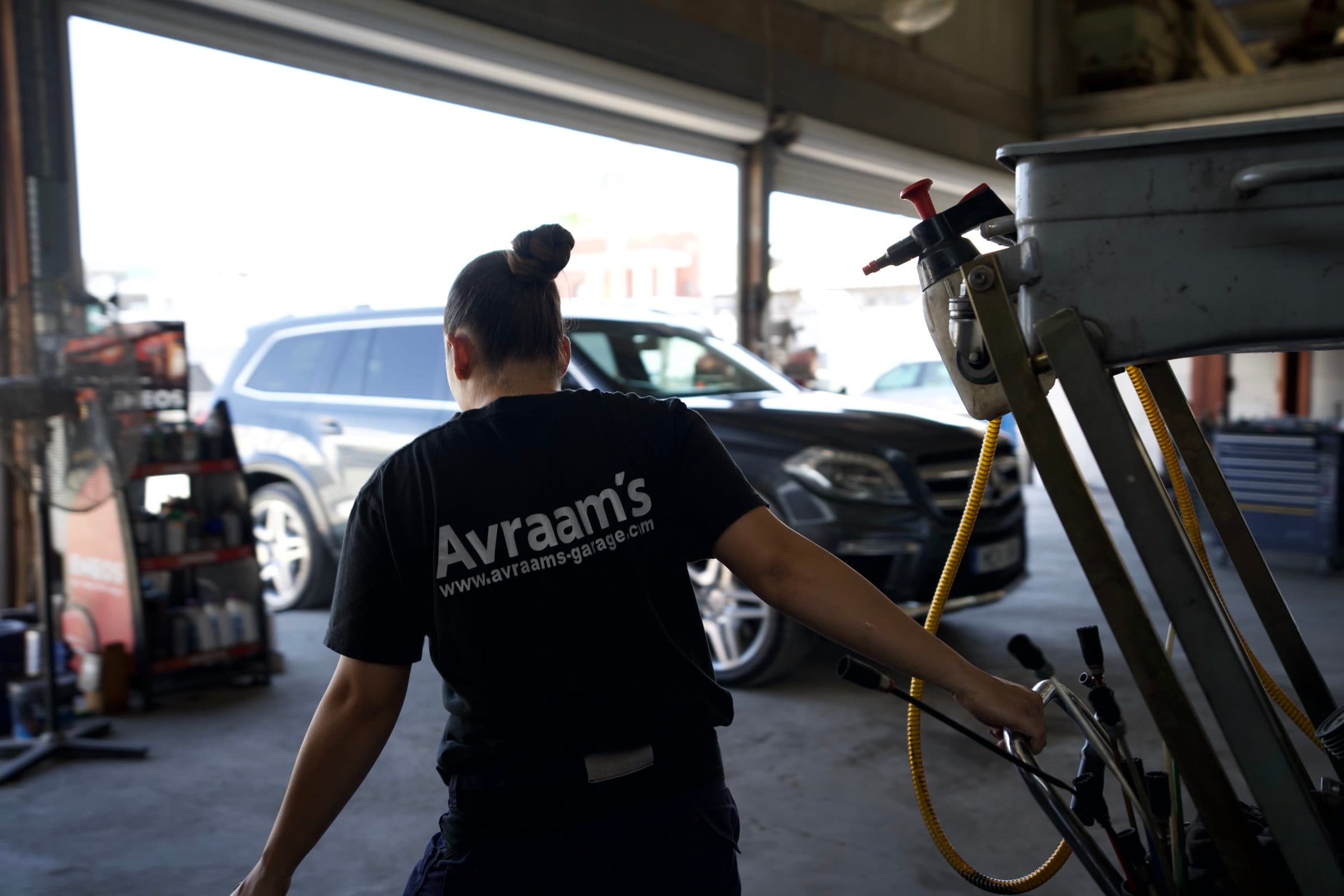 Draining oil beneath a car on the lift